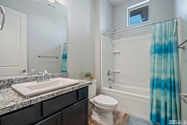 full bathroom featuring hardwood / wood-style floors, vanity, toilet, and shower / bathtub combination with curtain