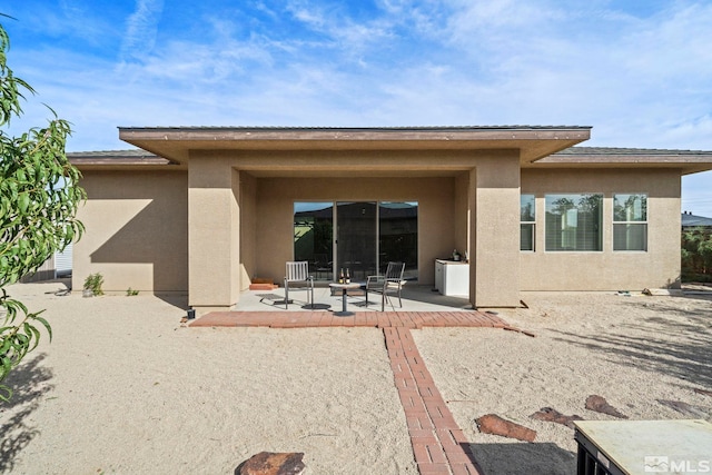 back of property with a patio area