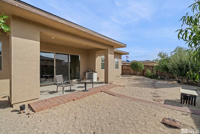 rear view of property featuring a patio