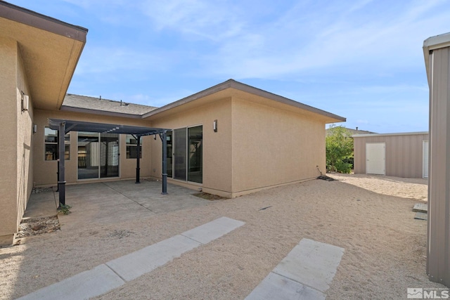 exterior space with a storage unit, a patio area, and a pergola