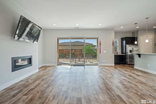 unfurnished living room featuring hardwood / wood-style flooring