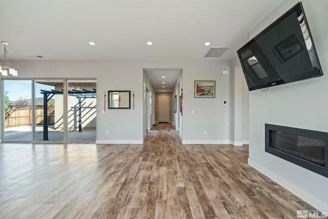 unfurnished living room featuring wood-type flooring