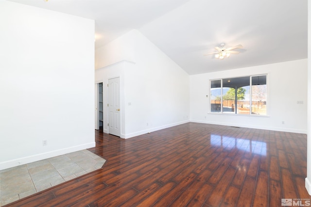 unfurnished room featuring ceiling fan, dark hardwood / wood-style floors, and vaulted ceiling