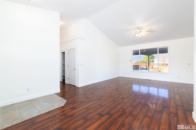 unfurnished living room with dark wood-style flooring, ceiling fan, baseboards, and lofted ceiling