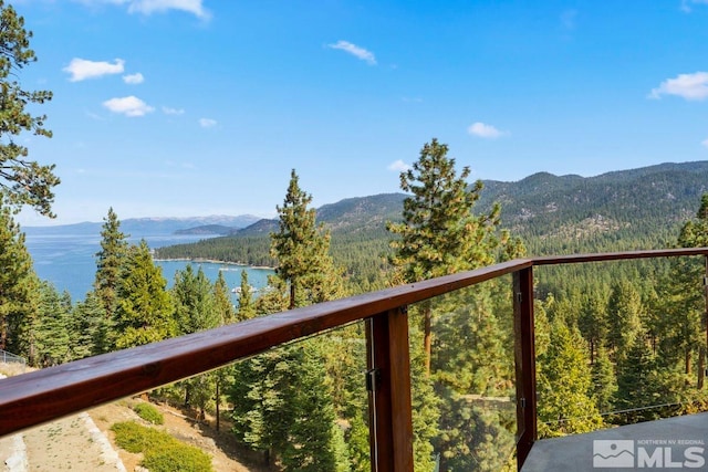 exterior space with a water and mountain view