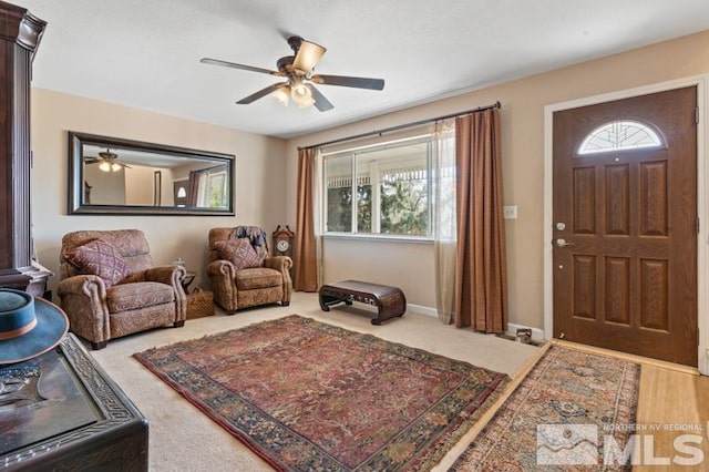 interior space featuring ceiling fan and carpet flooring