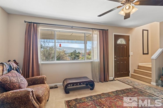 sitting room with ceiling fan and carpet flooring