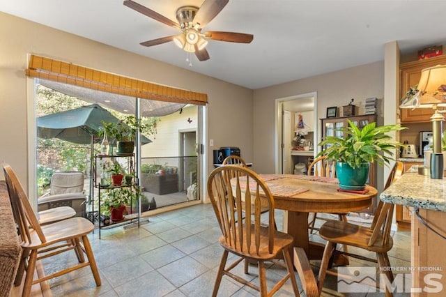 tiled dining room featuring a healthy amount of sunlight and ceiling fan