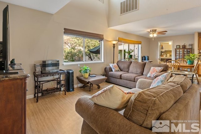 living room featuring light hardwood / wood-style floors and ceiling fan