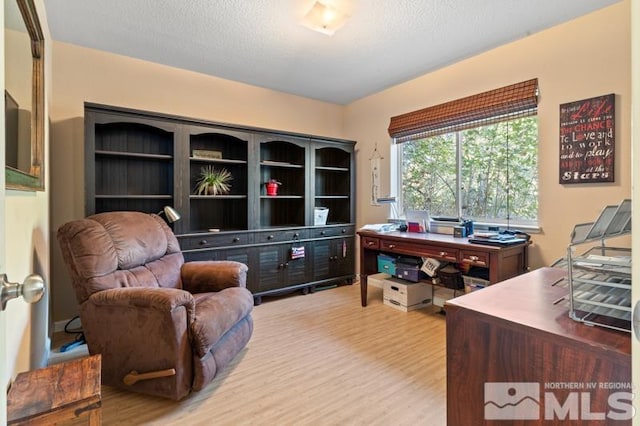 office featuring hardwood / wood-style floors and a textured ceiling