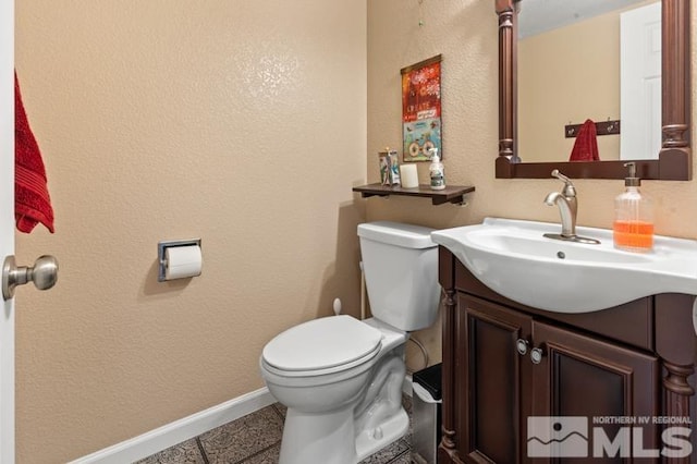 bathroom featuring vanity, toilet, and tile patterned flooring