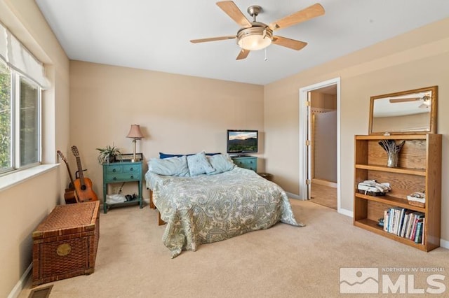 carpeted bedroom featuring ceiling fan and multiple windows