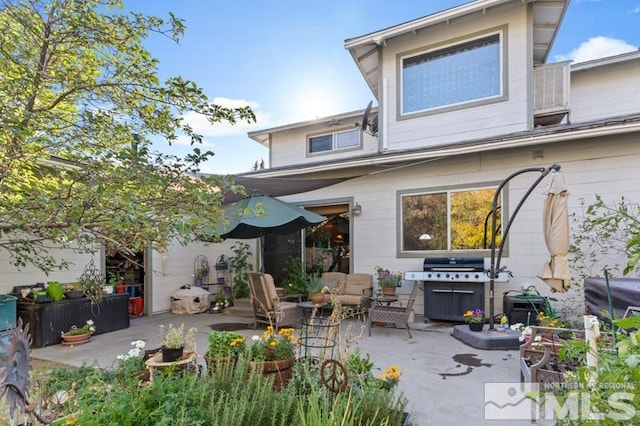 rear view of property featuring a patio