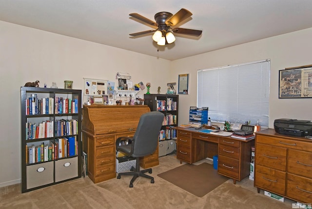 office space featuring light carpet and ceiling fan