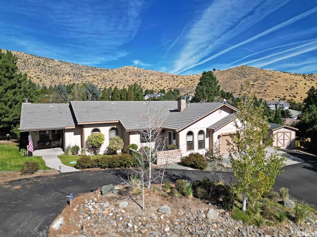 ranch-style home featuring a mountain view