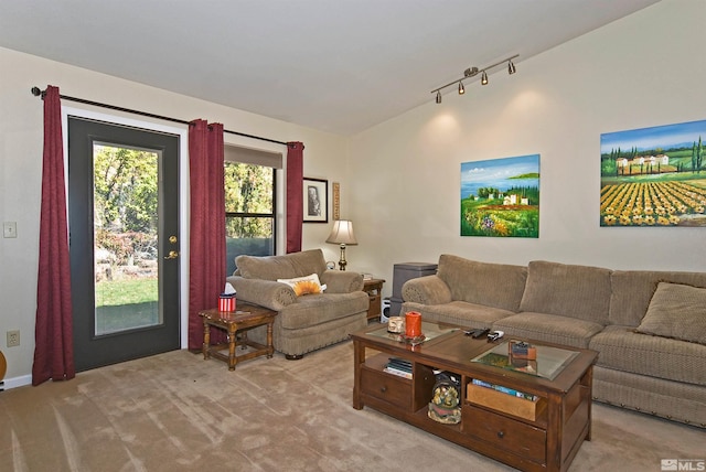 carpeted living room with track lighting