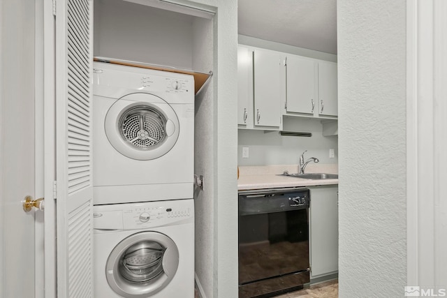 washroom featuring stacked washer / drying machine and sink