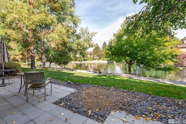 view of yard featuring a water view and a patio area