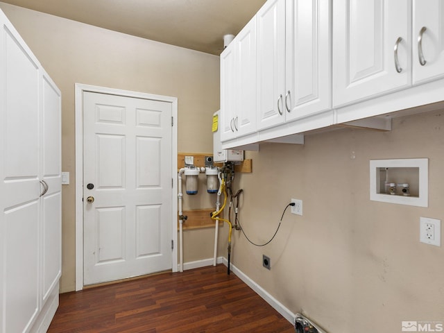 laundry area with washer hookup, water heater, dark wood-type flooring, and cabinets