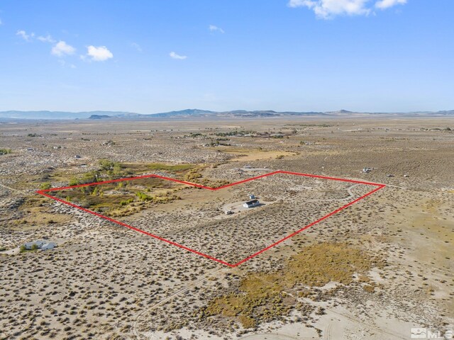 drone / aerial view featuring a mountain view