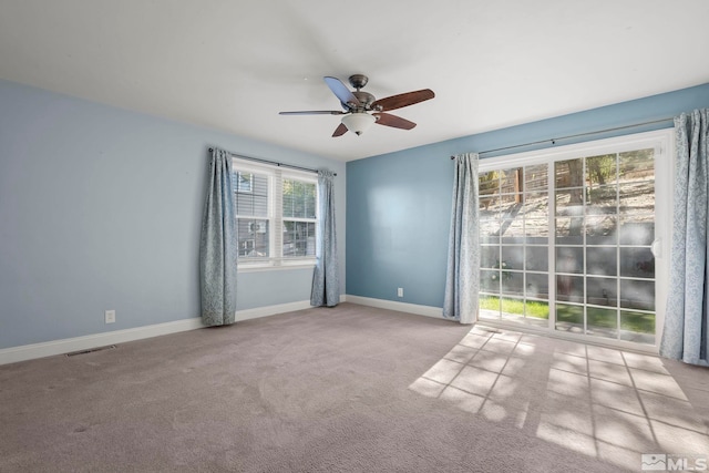 empty room with light colored carpet and ceiling fan