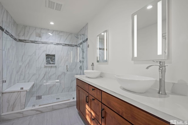 bathroom featuring tile patterned floors, an enclosed shower, and vanity