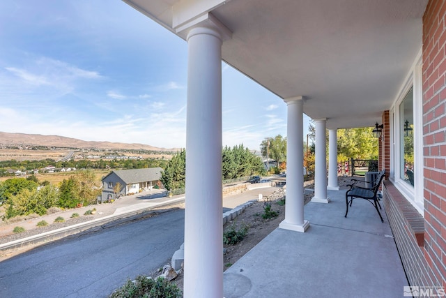 view of patio with a mountain view and covered porch