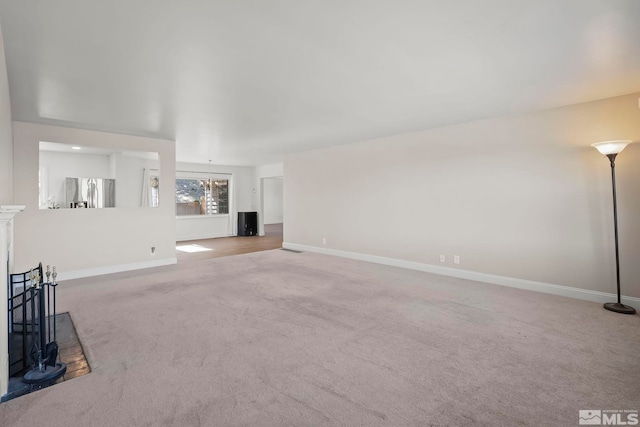 unfurnished living room with carpet flooring and a notable chandelier