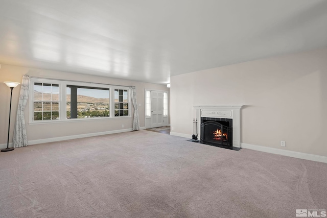 unfurnished living room with light carpet and a mountain view