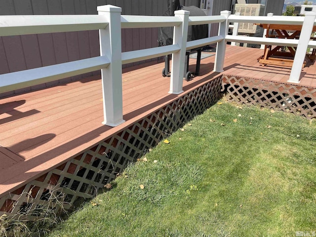 wooden terrace featuring a lawn