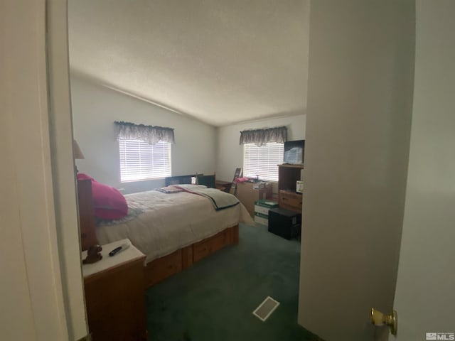 carpeted bedroom with vaulted ceiling