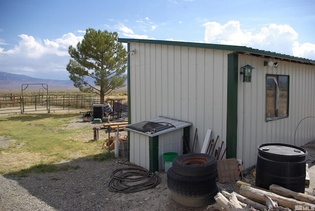 view of outbuilding featuring a mountain view and a rural view