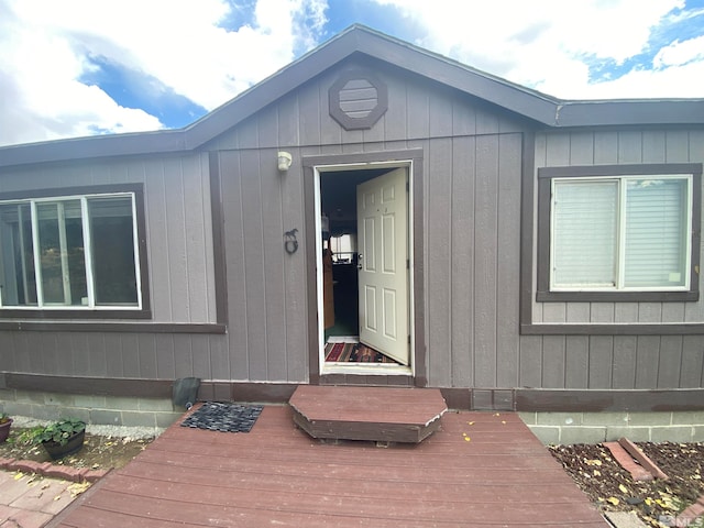 view of exterior entry featuring a deck