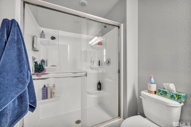 bathroom with walk in shower and toilet