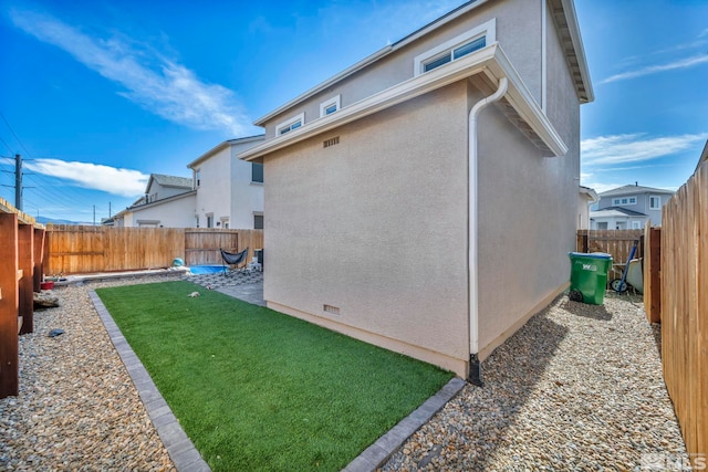 rear view of property featuring a yard