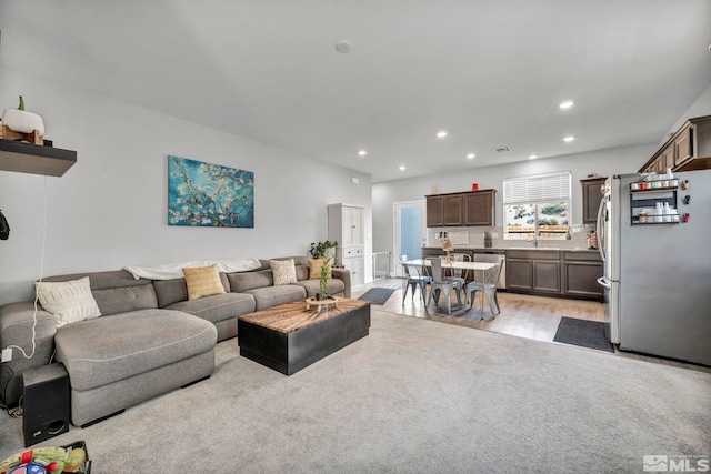 living room featuring light hardwood / wood-style floors and sink