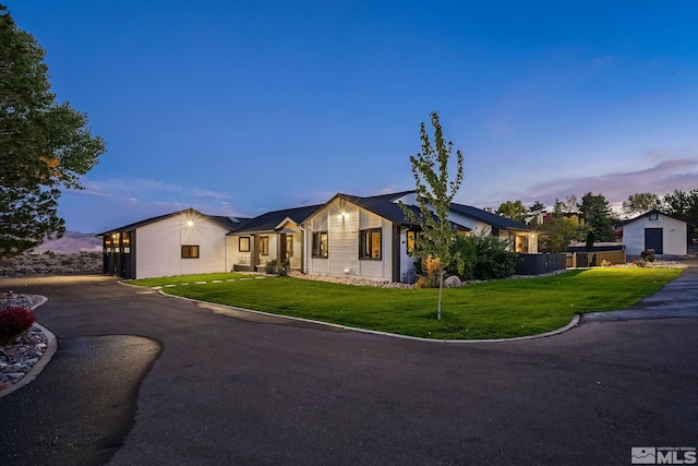 ranch-style home with a lawn