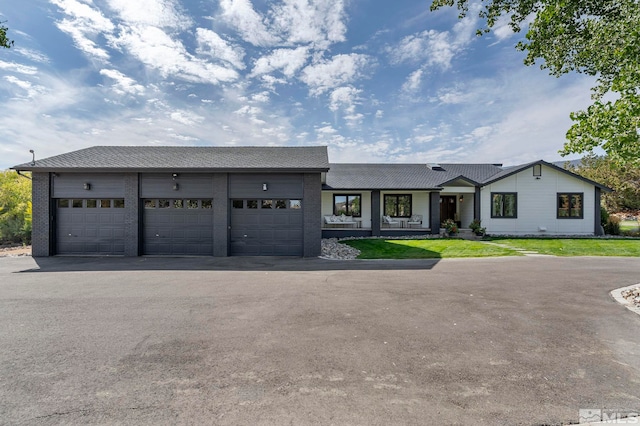 view of front of property with a front yard and a garage