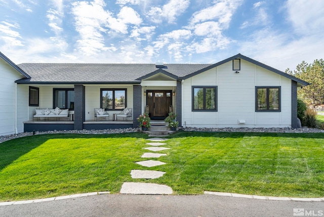 ranch-style house with a porch and a front lawn