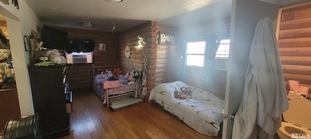 bedroom with hardwood / wood-style floors and cooling unit