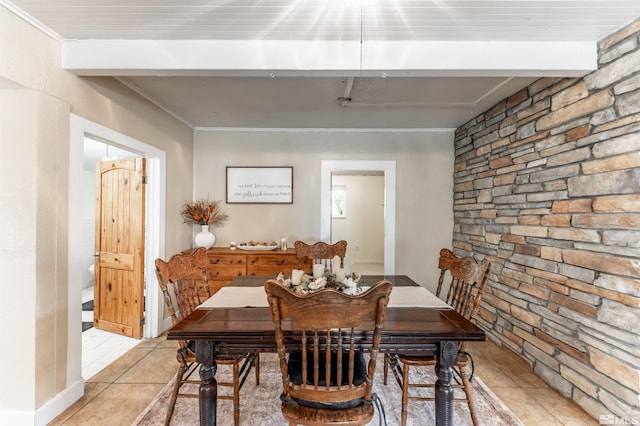 tiled dining space featuring crown molding