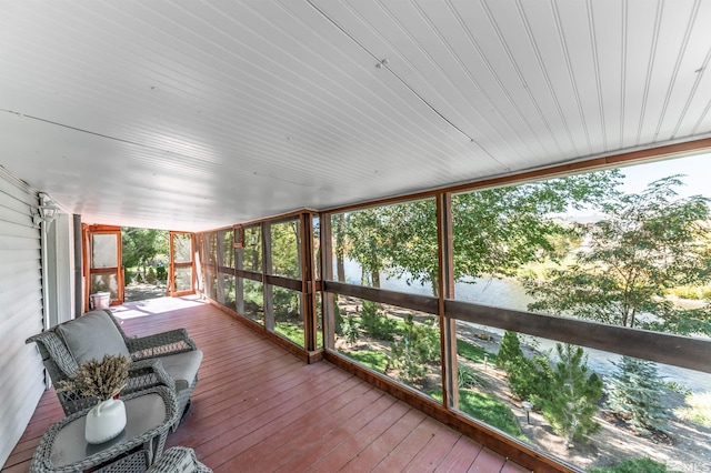 sunroom / solarium with a water view and wood ceiling