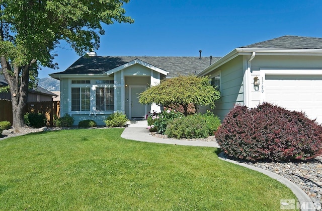 ranch-style home with a garage and a front lawn