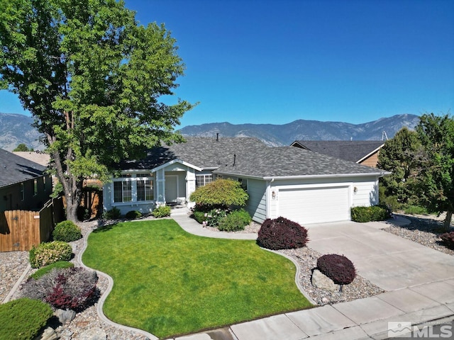 single story home featuring a garage, a front yard, and a mountain view