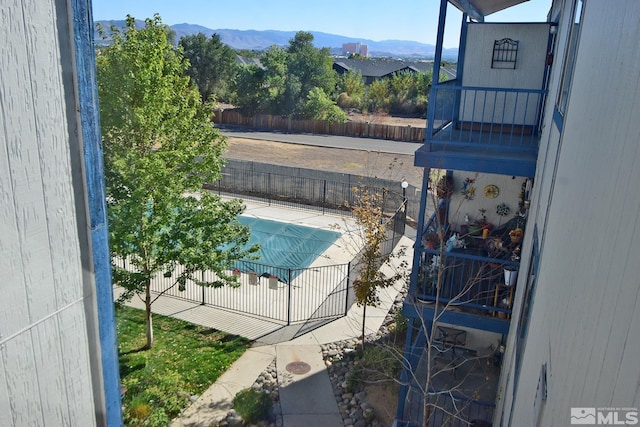 view of swimming pool featuring a patio and a mountain view