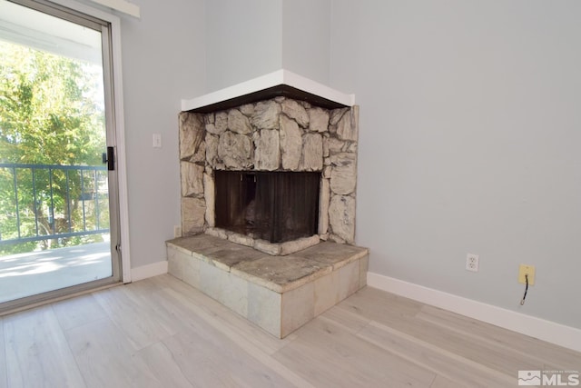 room details with a fireplace and hardwood / wood-style flooring