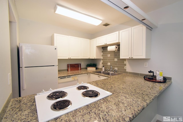 kitchen featuring sink, white appliances, backsplash, white cabinetry, and light stone countertops