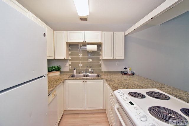 kitchen featuring white cabinets, sink, white appliances, light hardwood / wood-style flooring, and decorative backsplash