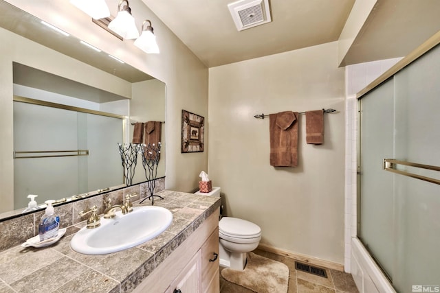 full bathroom featuring enclosed tub / shower combo, vanity, and toilet