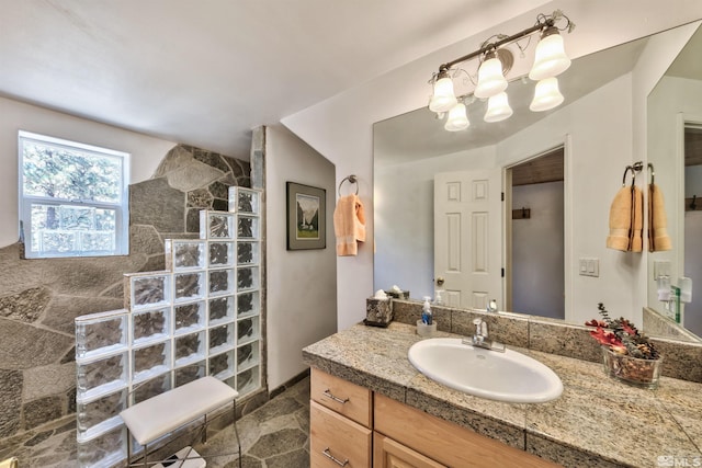 bathroom with walk in shower, vanity, tile walls, and an inviting chandelier